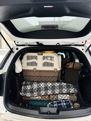 Family car trunk loaded with pet carrier and luggage for a road trip © AS Photo Family