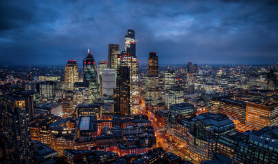 Panoramic aerial view of the illuminated City of London skyline with office skyscrapers and street traffic at Bishopsgate during dusk © moofushi