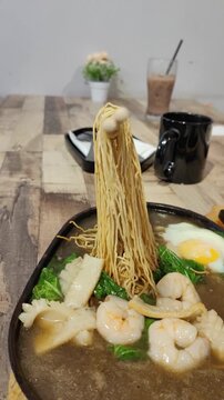Moving down, view a unique presentation on sizzling noodles.