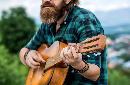 Acoustic guitars playing. Music concept. Guitars acoustic. Male musician playing guitar, music instrument. Music lifestyle man playing guitar nature concept. Hands of man musician playing guitar