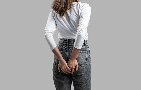 Hemorrhoids. . Woman suffering from hemorrhoids, anal pain. Woman hand holding her bottom because having Abdominal pain and Hemorrhoids