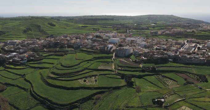 Aerial view of the verdant landscape and buildings, where the textures of the land meet the built environment, Gharb, Ta' Pinu Cathedral, Malta.