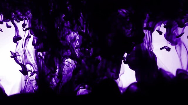 Slow motion close-up of purple smoke swirling in dark background