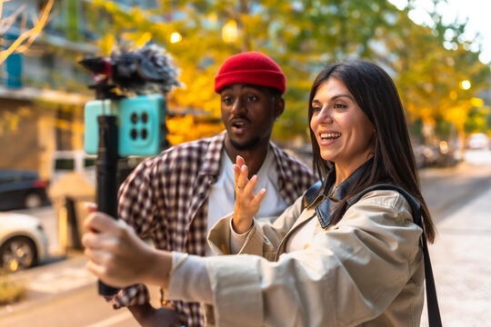 Young couple vlogging content outdoors using smartphone
