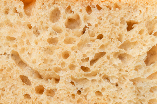Close-up of sliced ​​piece of whole grain bread. Bread crumb texture, artisan sourdough organic bread macro photography. Food background, bakery products