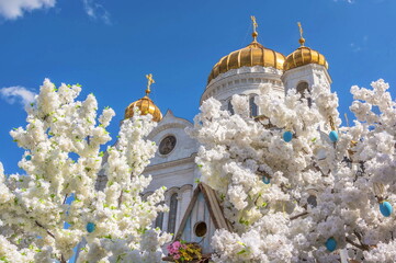 Easter eggs and flowering trees on background of the cathedral