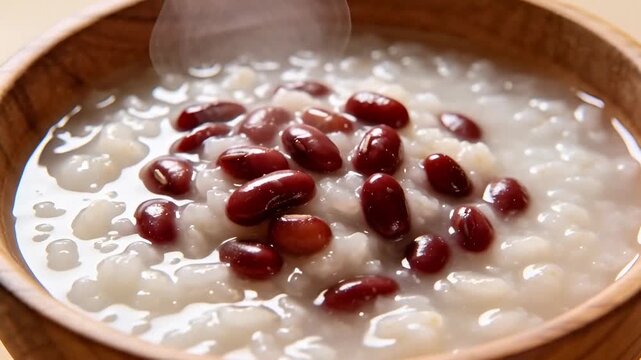 Steaming Red Bean Rice Porridge in Wooden Bowl