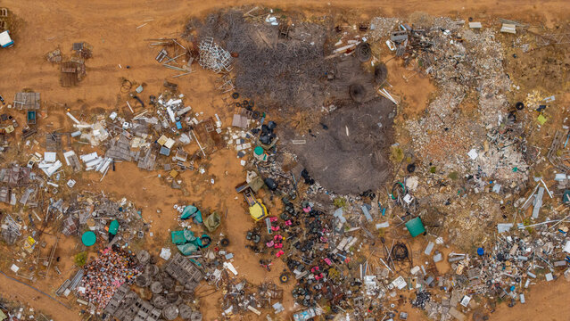 Aerial view of scattered refuse and debris creates a stark contrast against the arid landscape, a poignant reminder of environmental challenges, Touws River, Western Cape, South Africa.