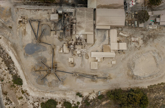 Aerial view of the industrial complex, a landscape of muted browns and grays, where heavy machinery and buildings blend into the earth tones, Robertson, Western Cape, South Africa.