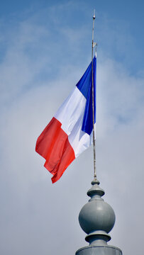 Large French National Flag with Soft Background of Clouds and Sky, Portrait