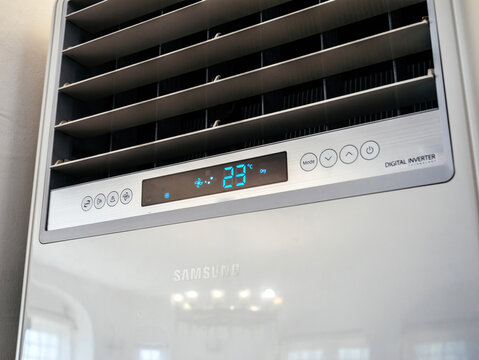 Balchik, Bulgaria, Aug 26, 2025: A Samsung digital inverter air conditioner displays 23C in Dry mode, showing vents and control icons in a bright indoor setting with reflections on its glossy surface