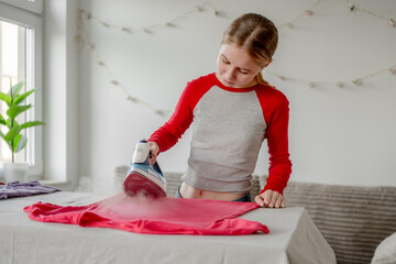 Teen Girl Ironing Shirt At Home