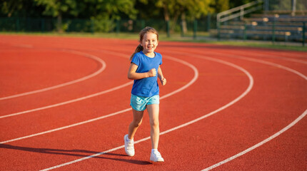 Obraz premium A happy fit girl and active child enjoys childhood fitness while having a run on a red outdoor track.