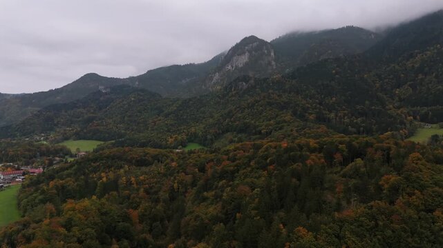 Aerial view of Schloss Hohenaschau castle in the Chiemgau Alps. Flugaufnahme foggy autumn morning near Aschau im Chiemgau with colorful forests and the rocky Kampenwand peak in Bavaria, Germany.