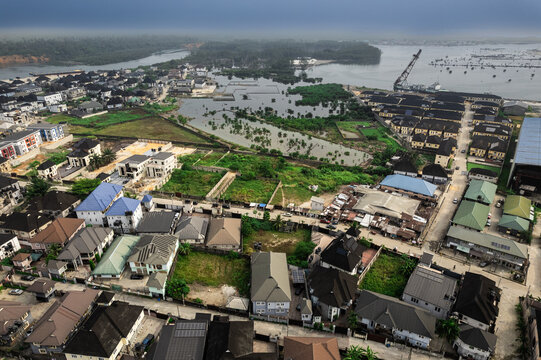 Aerial view of the buildings and roads contrasting with the lush greenery and water bodies around Didi Mc Close, Port Harcourt, Rivers, Nigeria.