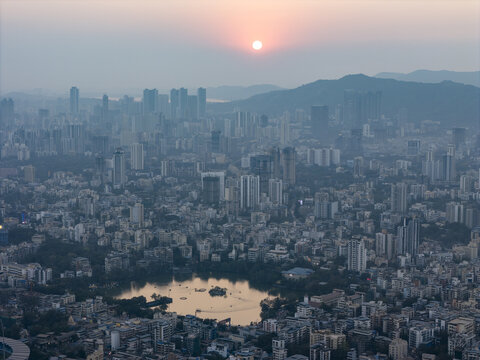 Aerial view of the serene Upvan Lake reflecting the soft glow of the setting sun amidst the dense urban sprawl, Thane, Maharashtra, India.