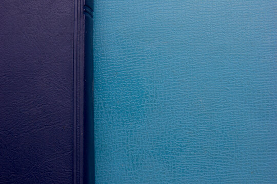 Close-up full frame photo of a stack of blue-covered Bibles, background and texture