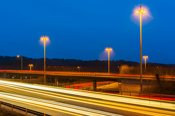 Car trails on motorways in M&ouml;lndal, Sweden showcase city movement at night with bright lights