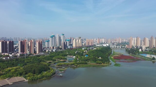 Urban Skyline with Red Algae Wetland Park and City Architecture
