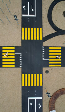 Aerial view of a playground mimicking traffic with bright yellow pedestrian crossings, guiding pedestrians, Monthey, Valais, Switzerland.