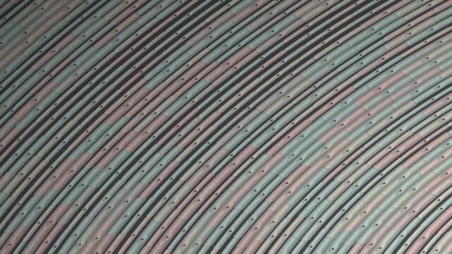 Close-up of a fabric with a multicolored, striped pattern in shades of pink, green, and black on a white background.