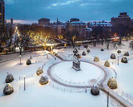 Aerial view of snow-covered Boston Public Garden with the George Washington Statue and a view toward Commonwealth Ave. Boston, Massachusetts, USA.