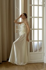 Fototapeta premium bride in white wedding dress in classical interrior, european model with classical appiarance