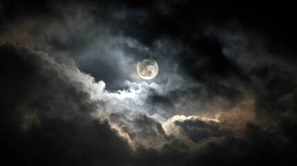 Obraz premium Full moon shrouded by thick clouds, diffused light, and dark sky. Atmosphere is eerie and mysterious