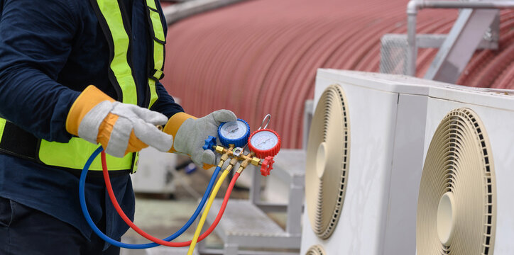 Technician is checking air conditioner ,measuring equipment for filling air conditioners.