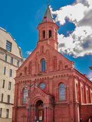 Stunning view of a Russian Orthodox church with bright golden domes against a clear blue sky. Architectural detail vibrant colors