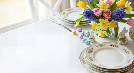 Happy easter sunday table setting with tulips and easter eggs decorations