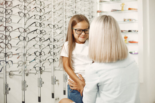 Family choosing glasses at optics store