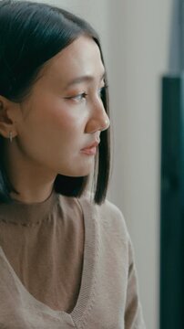 Vertical Screen : Young Asia female freelance typing write prompt AI bot IT app program nomad, video game, terminal with coding language, user interface, designer, big data center on desktop computer.