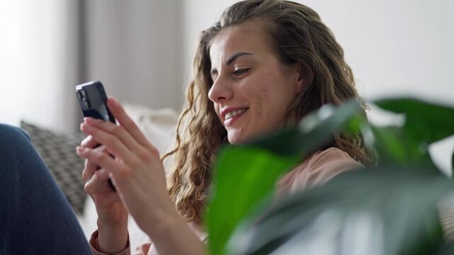 Relaxed and happy woman scroll social media and reading on her phone 