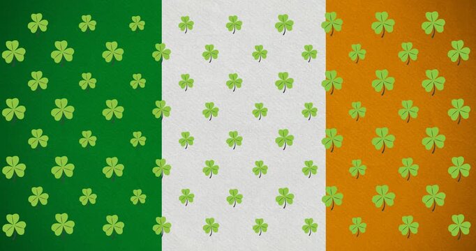Digital animation of multiple clover leaves moving against irish flag