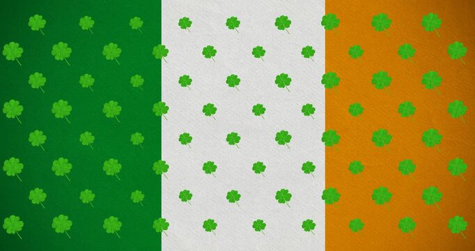 Digital animation of multiple clover leaves moving against irish flag