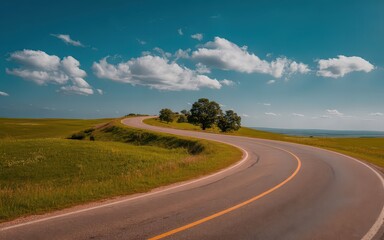 Curving road through lush green countryside.