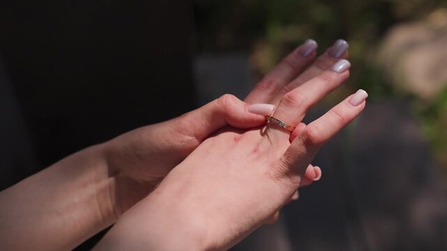 The bride holds a wedding ring in her hands