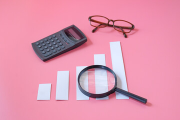 A magnifying glass with charts graphic bar. Financial development.