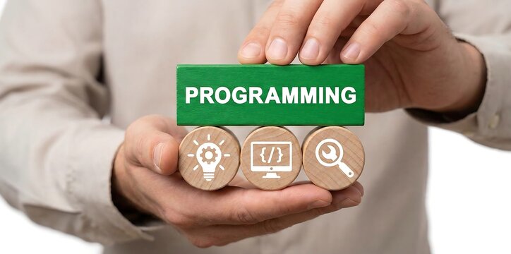 Man holding blocks with icons sees word: PROGRAMMING. Concept of computer programming or developing software, game, apps. Artificial coding, programming, information technologies. new