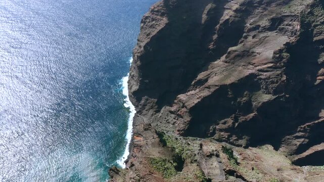Aerial Cinematic view of the towering Los Gigantes cliffs and the rugged Masca Gorge in Teno Rural Park Tenerife