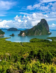 Green islands dot a bay with lush trees, against a blue sky with puffy white clouds