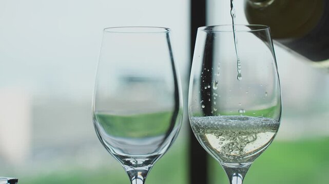 White wine is poured into glasses
