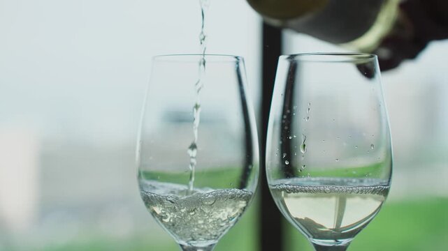 White wine is poured into glasses