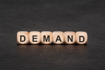 DEMAND word on wooden cubes, economic and business market concept. Conceptual pair with supply in...
