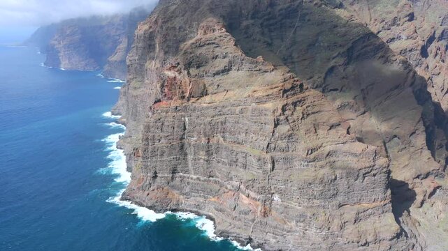 Aerial Cinematic view of the towering Los Gigantes cliffs and the rugged Masca Gorge in Teno Rural Park Tenerife
