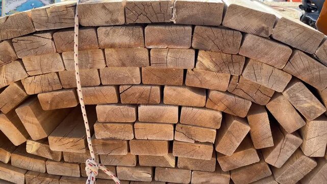 Stacked lumber pieces in warehouse forming unique textured background with rustic appearance