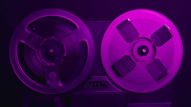 Tape audio music player, VHS studio magnetic tape, vintage retro spool reel to reel player and recorder, magnetic tape data storage close up, music studio. 