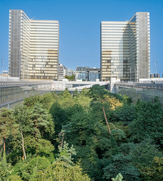 Paris, France - 09 20 2021: Bibliotheque Nationale de France Fran&ccedil;ois-Mitterrand. Panoramic view of two of the four L-shaped glass towers of the Library and the garden forest below