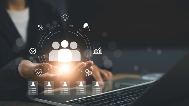 Digital icons of team, profile data, and management analytics float laptop, representing human resource management, employee performance tracking, and business leadership solutions.